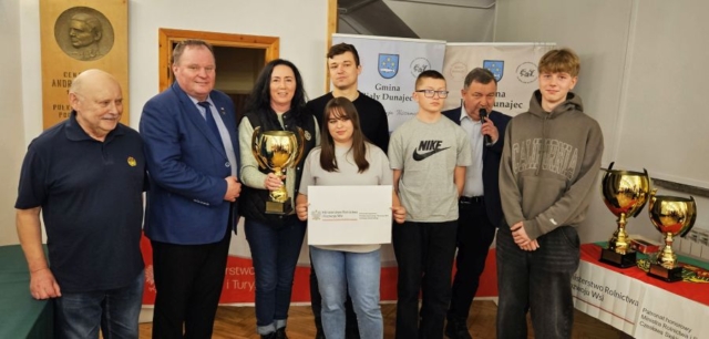 rajd_podhalanski07 Zdjęcie przedstawia 3 uczestników rajdu wraz z opiekunem i 4 osobami dorosłymi. Opiekun grupy trzyma w ręku puchar, a jedna z uczestniczek rajdu kartkę z napisem Ministerstwo Rolnictwa i Rozwoju Wsi - patronat wydarzenia.