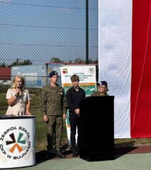 rozpoczecie15 Boisko szkolne Orlik przy ZS CKZ w Bujnach. Uroczystość rozpoczęcia roku szkolnego. Pani Dyrektor przemawiająca do zebranych oraz uczniowie prowadzący uroczystość. Rozwinięta flaga Polski oraz rollup promocyjny Szkoły.