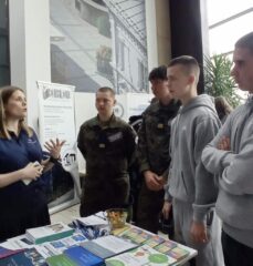 mediateka_3 Uczniowie rozmawiają przy stanowisku informacyjnym biblioteki.